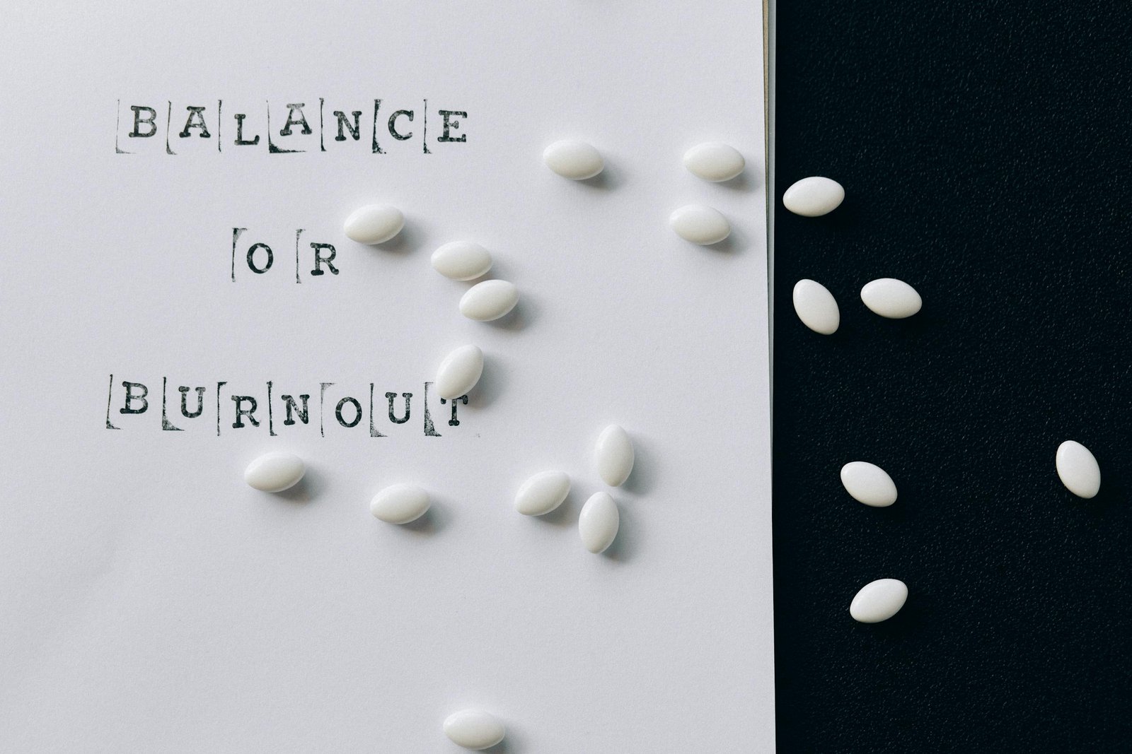 Conceptual image featuring 'Balance or Burnout' text with scattered white capsules.